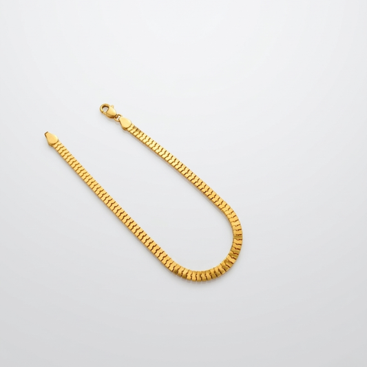 21k Gold chain bracelet on a light gray background