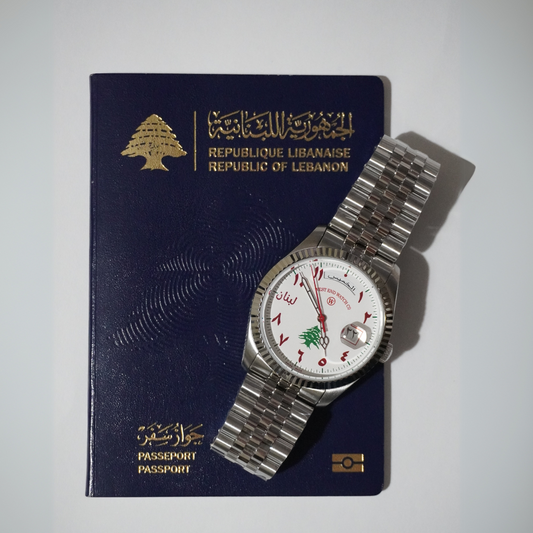 Lebanon Watch next to Lebanese passport on white background