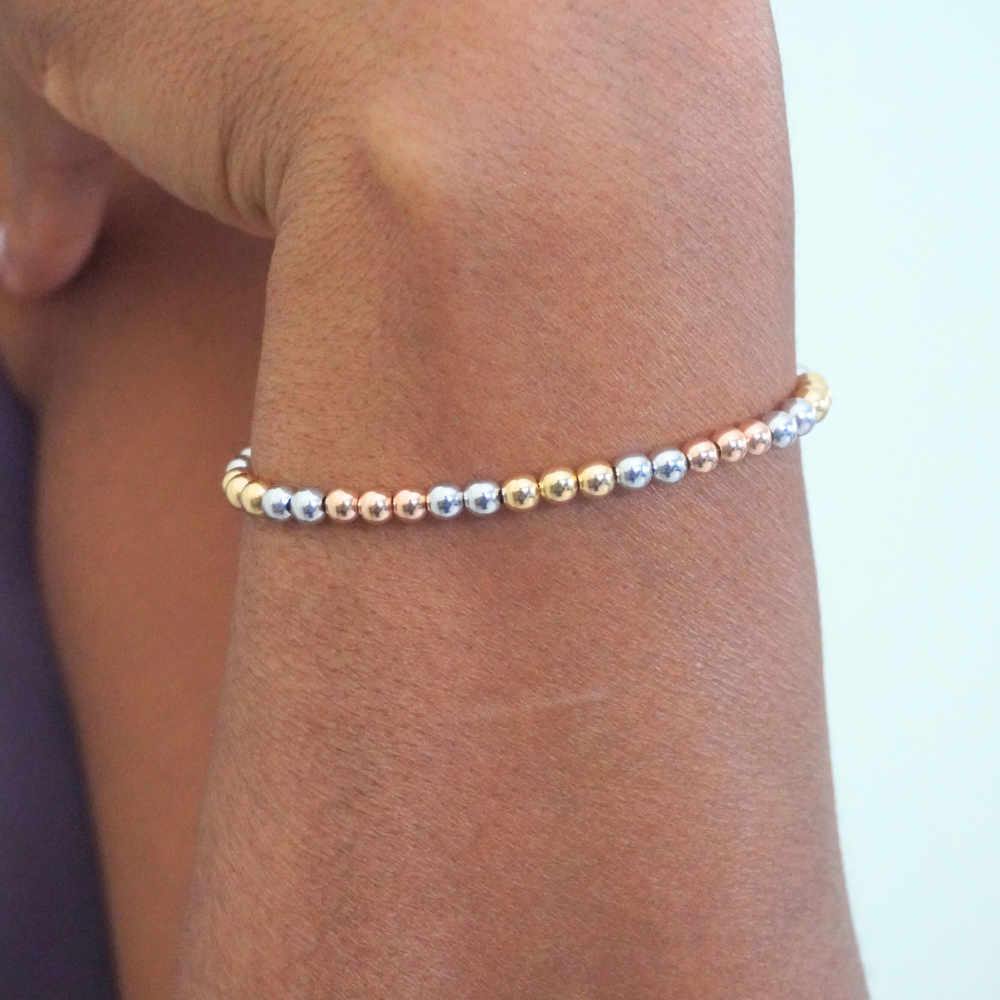 Multicolored beaded bracelet on a wrist with a light background
