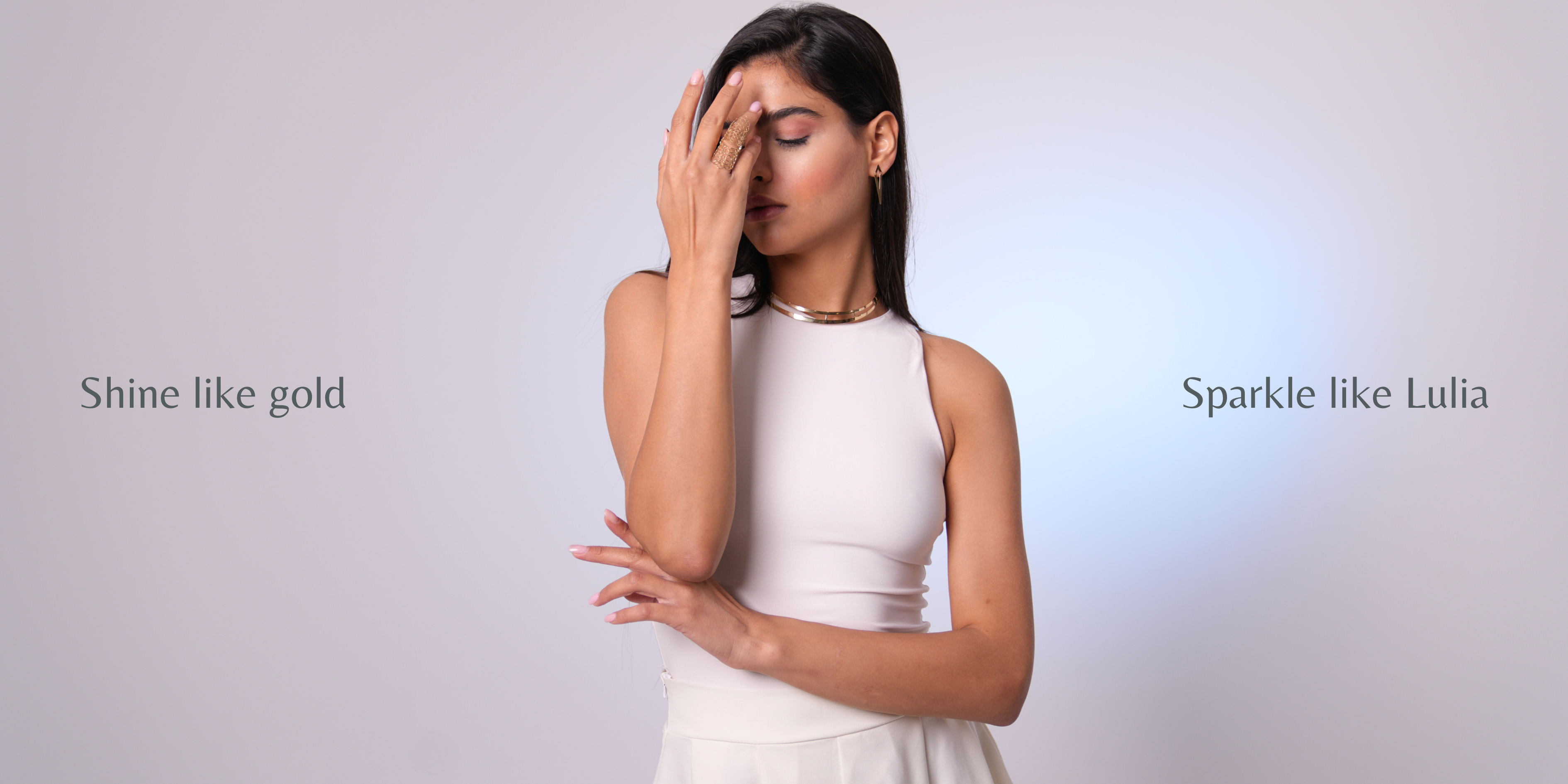 Woman in a white dress with text 'Shine like gold' and 'Sparkle like Lulia' on a light gray background