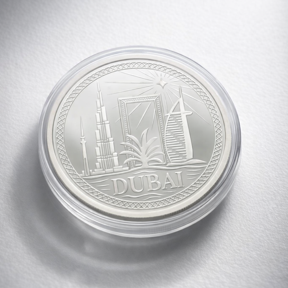 Silver coin with 'Dubai' text and architectural design on a white background