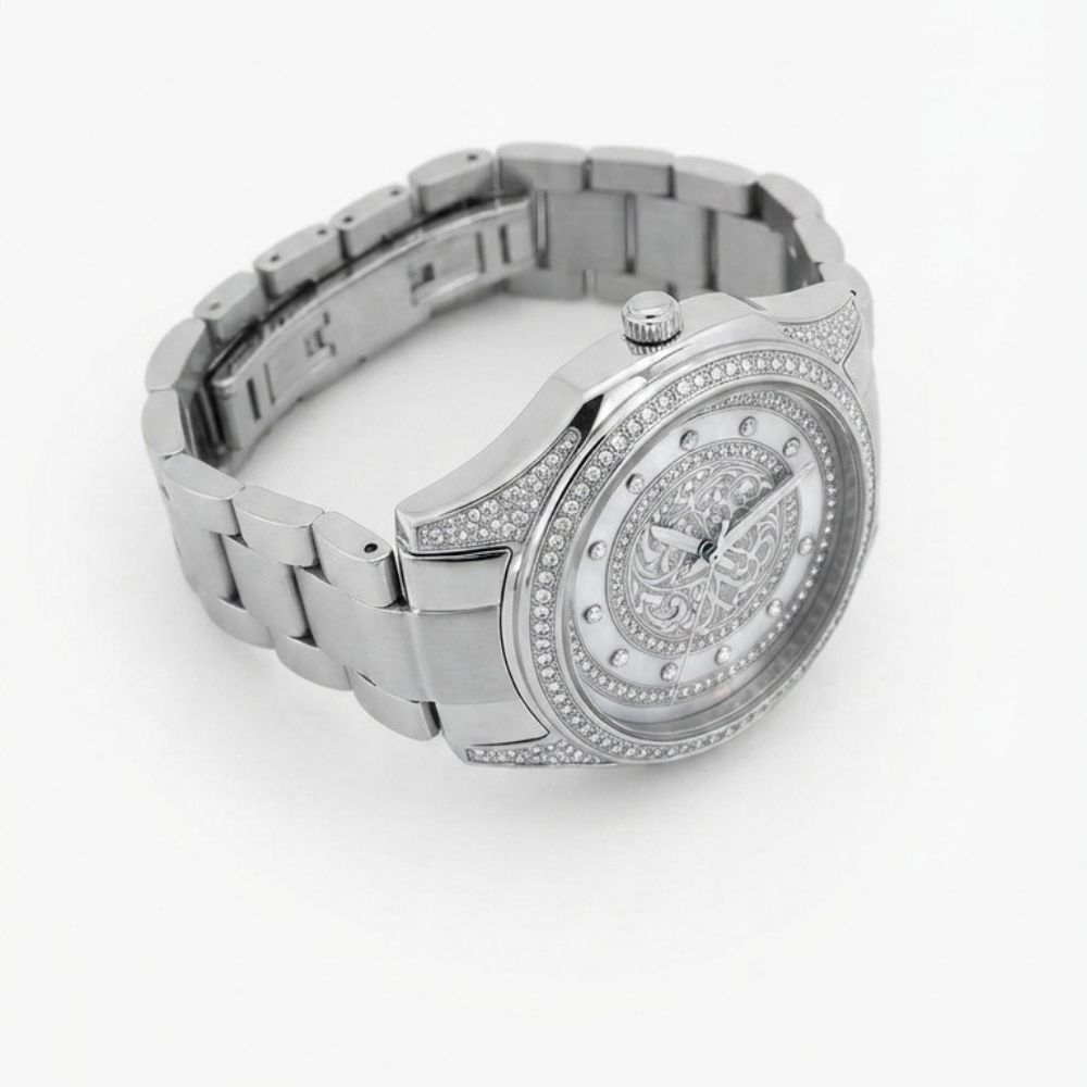 A Tony Valentino silver-tone stainless steel watch with a matching link bracelet, featuring a round bezel set with small clear crystals, a detailed ornate dial, and crystal hour markers on a white background.