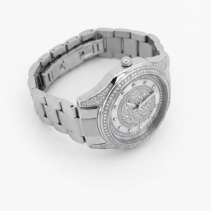 A Tony Valentino silver-tone stainless steel watch with a matching link bracelet, featuring a round bezel set with small clear crystals, a detailed ornate dial, and crystal hour markers on a white background.