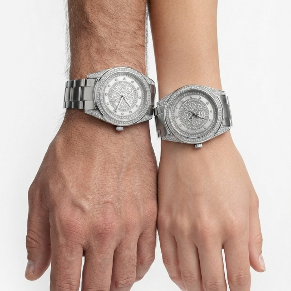 Tony Valentino  Two wristwatches with silver-toned metal bracelets and crystal-encrusted dials, shown worn on two human wrists against a plain light background.