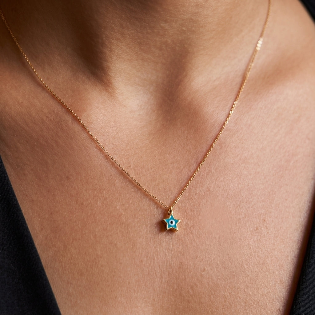 Mini star and eye – gold necklace