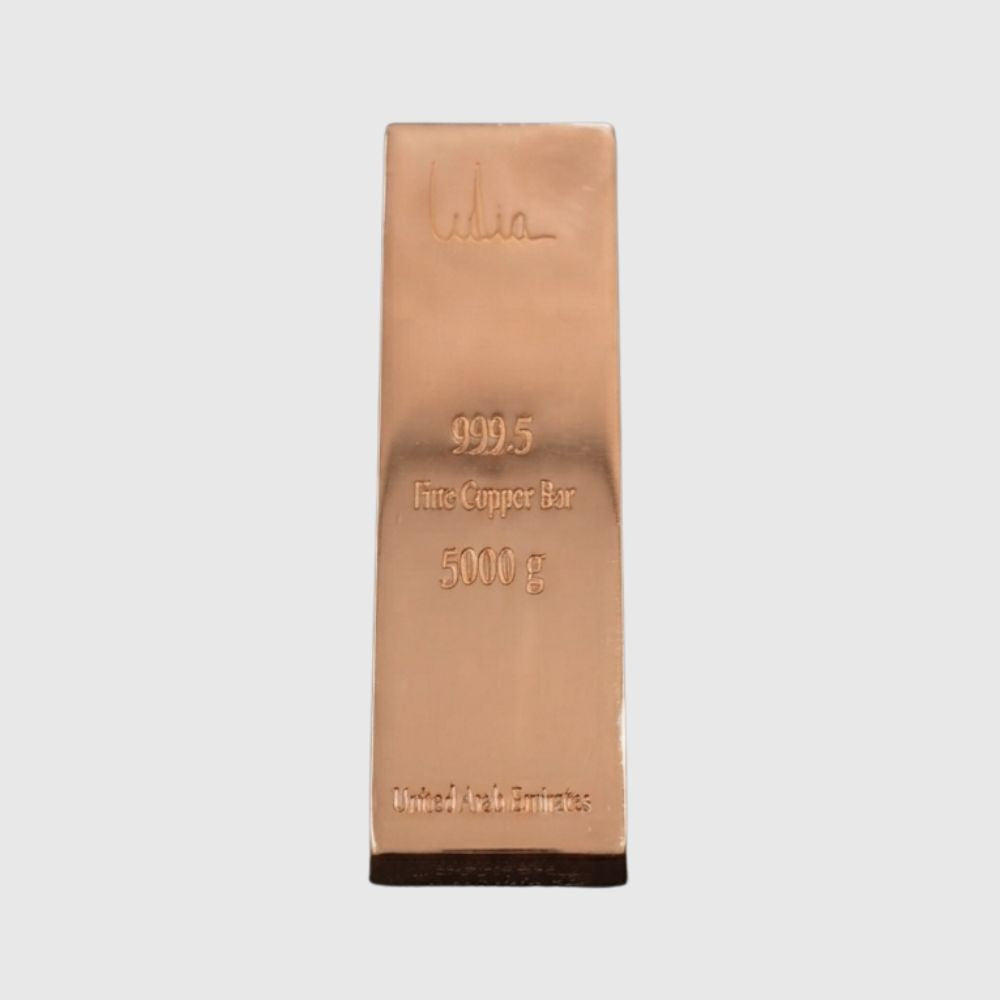 A 5000 g fine copper bar, 999.5 purity, featuring a polished rose gold metallic finish with an embossed signature and specifications, set against a plain light gray background.