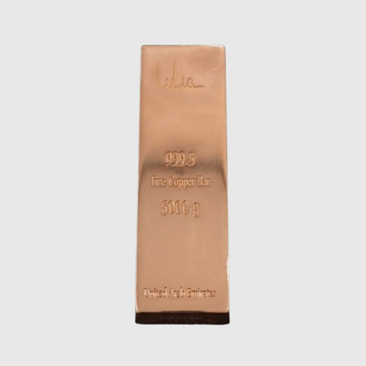 A 5000 g fine copper bar, 999.5 purity, featuring a polished rose gold metallic finish with an embossed signature and specifications, set against a plain light gray background.