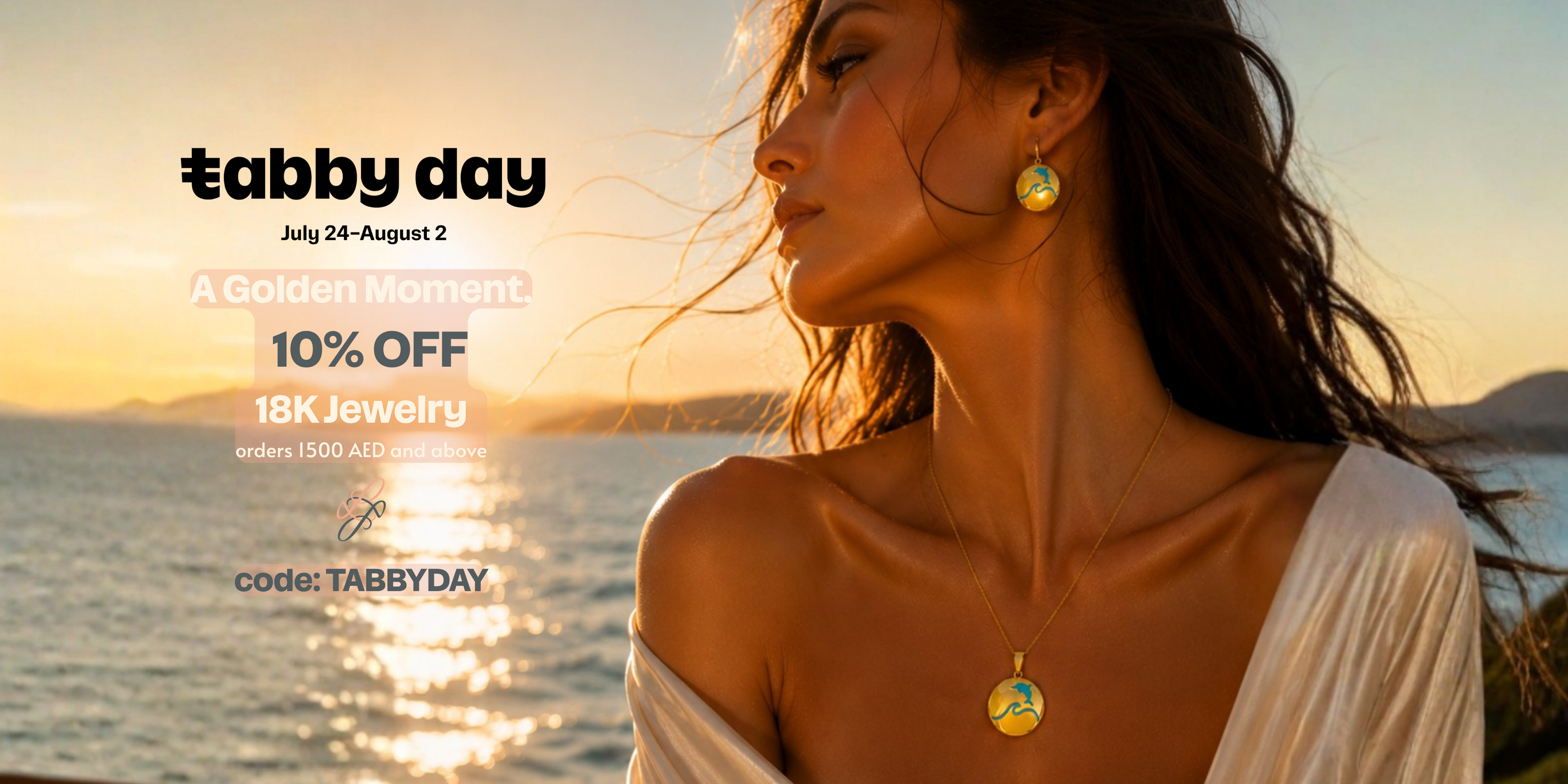 A woman in a white off-the-shoulder top wearing a gold pendant necklace and matching gold earring, photographed outdoors by the sea at sunset. Promotional text on the left reads 'tabby day' with sale details for 18K jewelry.