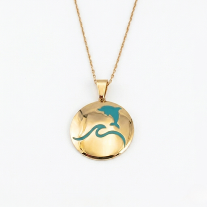 That's so summer - lulia jewelry Gold necklace with a round pendant featuring a dolphin and wave design on a white background